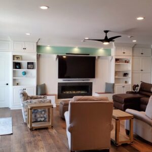 Wall with built-in cabinets surrounding TV and fireplace.