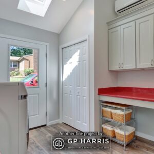 Closet and storage area of red and white laundry room addition.