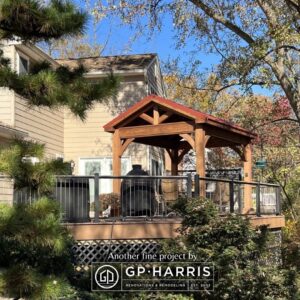 Beautiful wood gazebo with stunning trees around it.