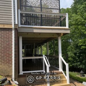 Stairs on the lower level with an upper level deck that has a beautiful railing and privacy panel.